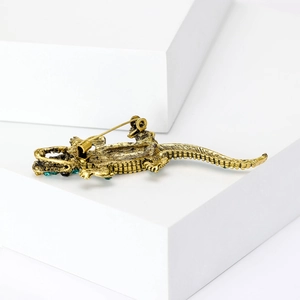 Detailed back view of crocodile brooch showing the sturdy metal safety pin and craftsmanship