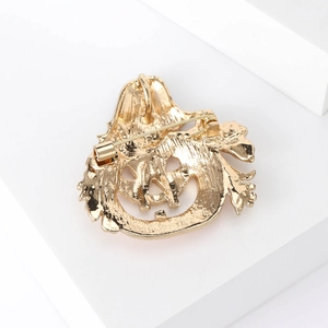 Golden Halloween pumpkin brooch pendant with textured metal back and dual-use pin