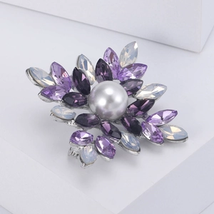 Detailed close-up of a flower brooch with purple crystals and center silver pearl