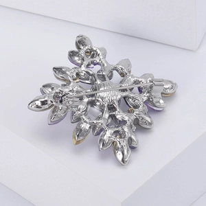 Back view of snowflake brooch with purple crystals and secure rotating safety pin