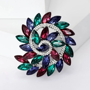 Detailed close-up of a spiral floral brooch with multicolor marquise-cut rhinestones