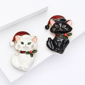 Set of two cute Christmas cat enamel pins with red holiday hats on white stone