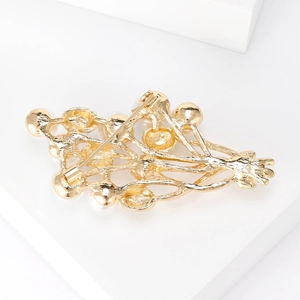 Elegant gold pearl flower brooch with secure pin buckle on minimalist white display stand