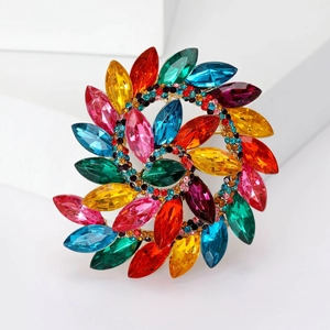 Macro shot of bohemian crystal sunflower brooch with colorful rhinestones on golden base