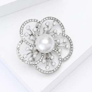 Detailed macro view of the alloy flower brooch with sparkling rhinestones and white pearls