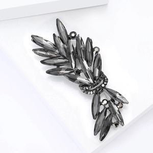 Macro detail of luxury dark grey crystal brooch with marquise stones in black gunmetal base