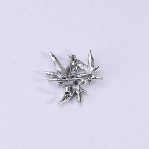 Back view of silver alloy bamboo leaf brooch with detailed veins and safety pin clasp