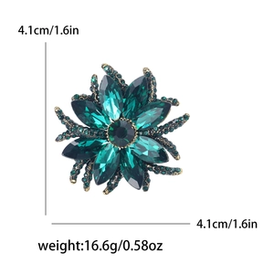 Dark green flower brooch with crystals and vintage metal base measuring 4.1cm by 4.1cm