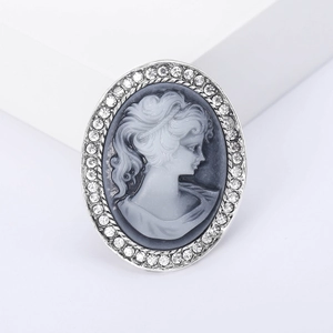 Vintage oval cameo brooch featuring a queen head relief with sparkling crystal border