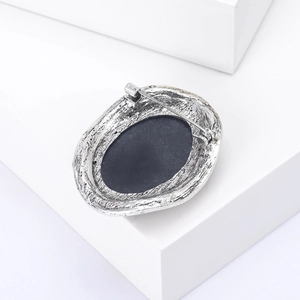 Detailed back view of vintage oval brooch with silver alloy texture and sturdy pin fastener
