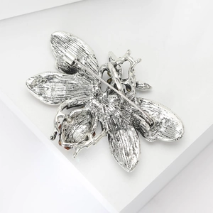 Detailed back view showing the silver alloy bee brooch pin with secure metal fastener