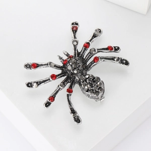 Gothic spider brooch with red and grey rhinestones set in silver-tone alloy metal