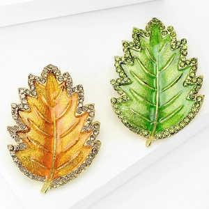 Leaf brooch pins with colorful enamel finish and crystal accents on a white background