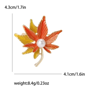 Golden maple leaf brooch with orange enamel and pearl, dimensions 4.3cm by 4.1cm