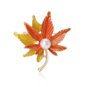 Elegant maple leaf brooch with orange yellow enamel and white pearl on golden alloy base