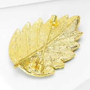 Detailed back view of gold leaf brooch showing pin fastener and leaf vein texture