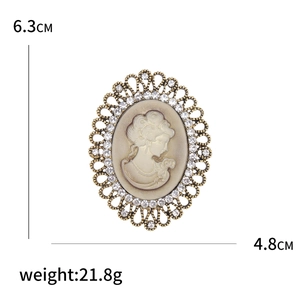 Vintage cameo brooch with rhinestone embellishments and measurements 6.3cm x 4.8cm