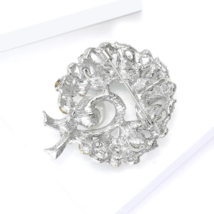 Detailed back view of silver wreath brooch featuring a security clasp and pearl inlay