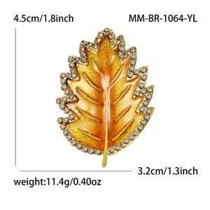 Leaf brooch with yellow enamel and rhinestones in gold tone, dimensions 4.5cm by 3.2cm