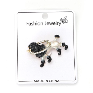 Close-up of poodle brooch with black and white enamel and sparkling rhinestone collar