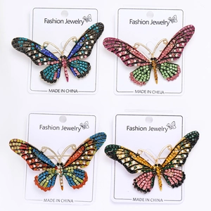 Detailed view of colorful rhinestone butterfly brooches in four diverse color patterns