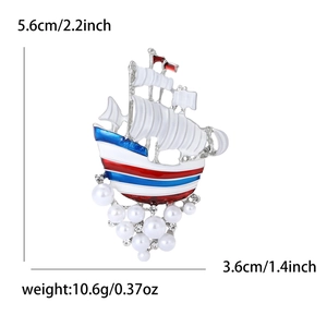 Enamel sailboat brooch with pearls and rhinestones showing 5.6cm by 3.6cm dimensions