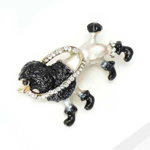 Detailed view of poodle enamel brooch with gold alloy finish and sparkling rhinestones