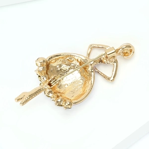 Detail view of dancing ballerina brooch showing the secure safety pin back and gold plating