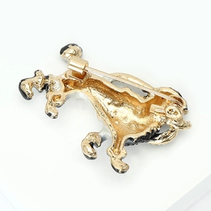 Close-up detail of dog-shaped enamel brooch back with secure metal safety pin clasp