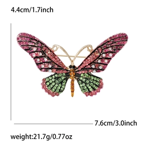 Detailed size view of a butterfly brooch with pink and green rhinestones and measurements
