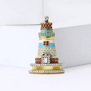Elegant gold-tone lighthouse brooch with colorful enamel and sparkling rhinestones
