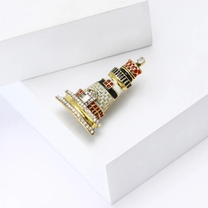 Macro view of lighthouse brooch featuring gold plating, enamel and sparkling rhinestones