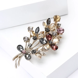 Close-up of vintage flower brooch with colorful rhinestones and black resin roses