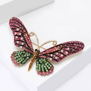 Detailed macro view of colorful rhinestone butterfly brooch with golden alloy setting