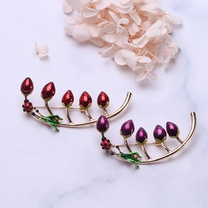 Elegant gold leaf brooches with colorful flower buds and small ladybug accents