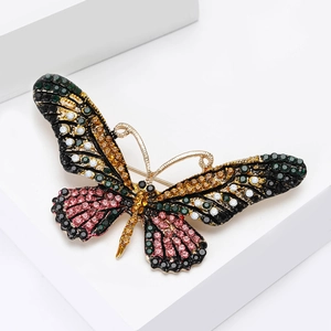 Close-up of alloy butterfly brooch with multicolored rhinestones and gold-tone base detail
