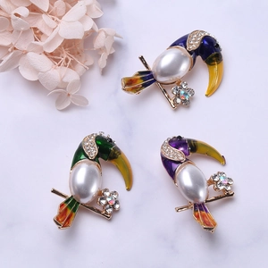 Elegant toucan bird brooch with white pearls, colorful enamel and rhinestones on gold base