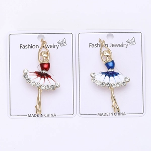 Detailed close-up of elegant enamel dancing girl brooches with crystals on white card