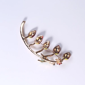 Golden alloy branch brooch with colorful enamel leaves and secure pin closure back