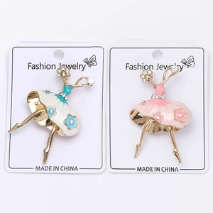 Detail of ballet dancer brooches in gold finish with pink and blue floral enamel skirts