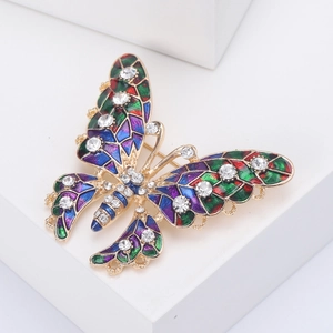 Detail of colorful enamel butterfly brooch with crystals on white display stand