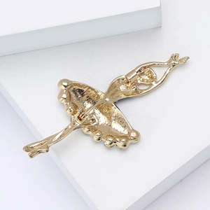 Close-up of the golden ballet girl brooch back with secure pin clasp on white background