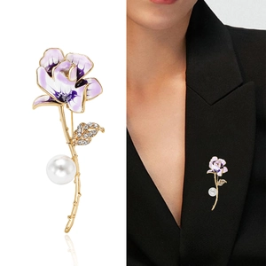 Elegant gold flower brooch with purple enamel petals, pearl detail and sparkling rhinestones