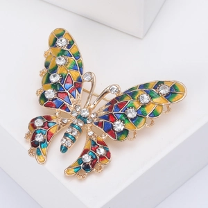 Macro shot of colorful enamel butterfly brooch with crystal diamonds and gold base