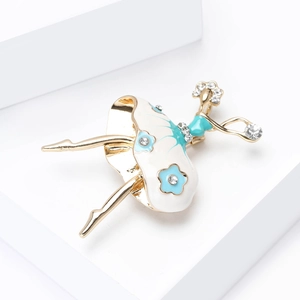 Elegant ballerina brooch with crystals and blue floral enamel on white geometric stand