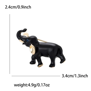 Spilla a forma di elefante in smalto nero e oro con gemma blu, misura 3,4cm x 2,4cm