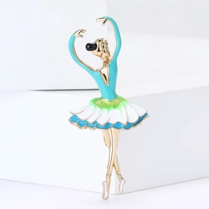 Elegant gold dancing ballerina brooch with green enamel gradient on a minimalist stand