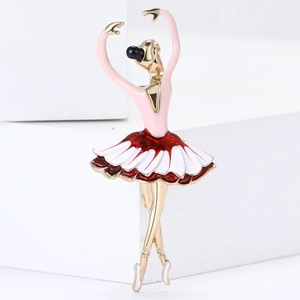 Detail of elegant ballerina brooch with red enamel skirt on artistic white blocks