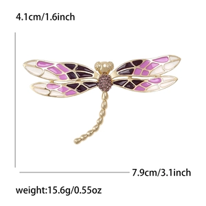 Broche libellule raffinée avec ailes en émail violet et strass sur monture dorée