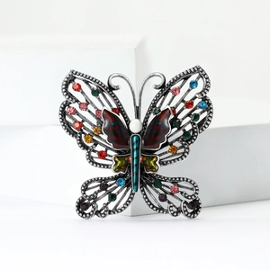 Detailed macro view of retro butterfly brooch with multi-color rhinestones and enamel craft